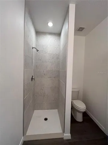 a bathroom with a shower and a toilet