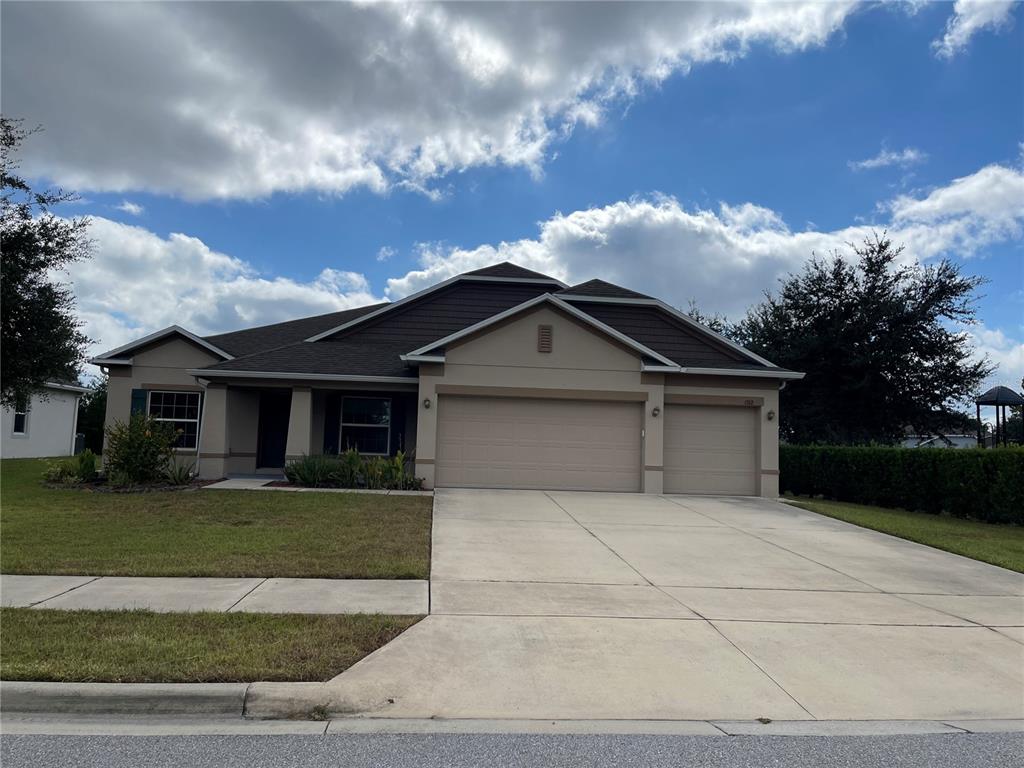 a front view of a house with a yard and garage