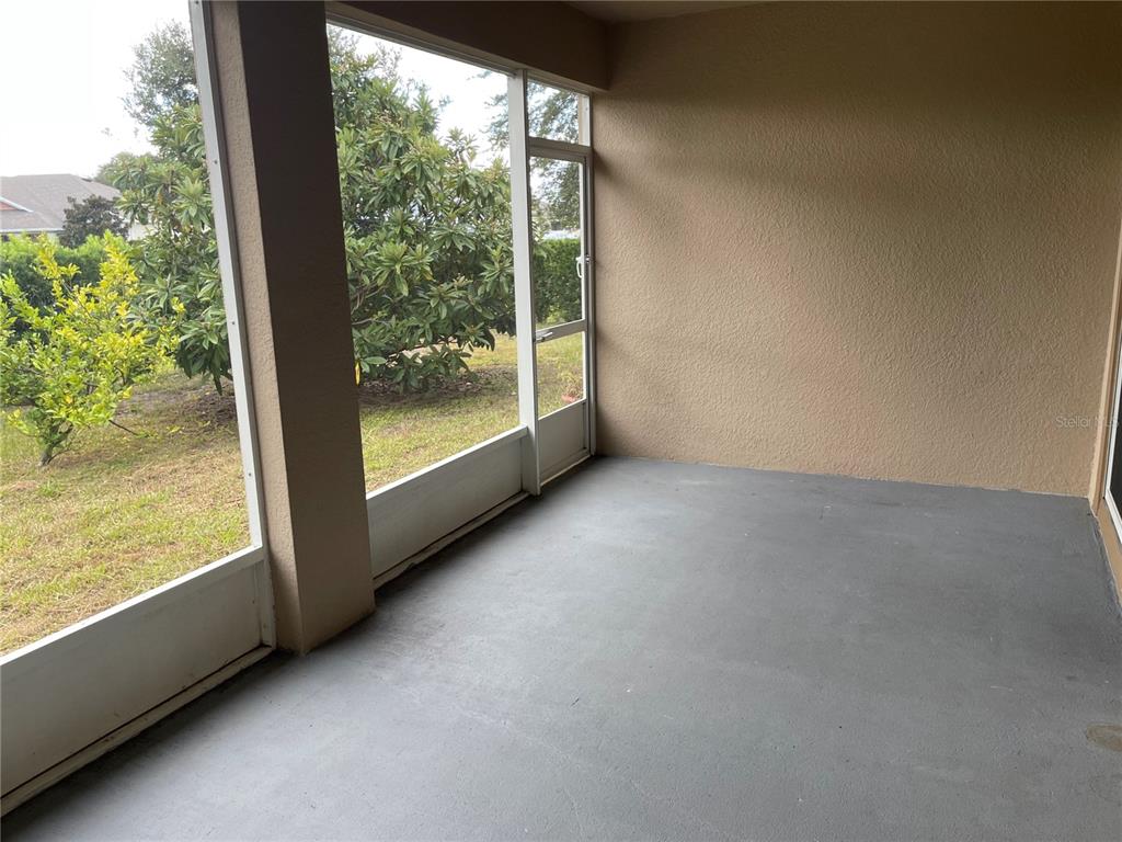 1312 Ralph Poe Drive Apopka, FL 32703 - Photo 13 of 14 an empty room with wooden floor and windows