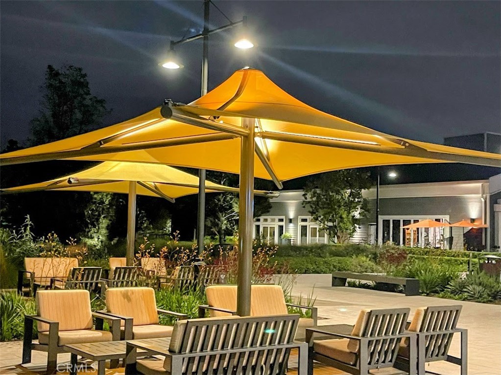 8 Coldstream Irvine, CA 92604 - Photo 19 of 27 a patio with a table and chairs under an umbrella