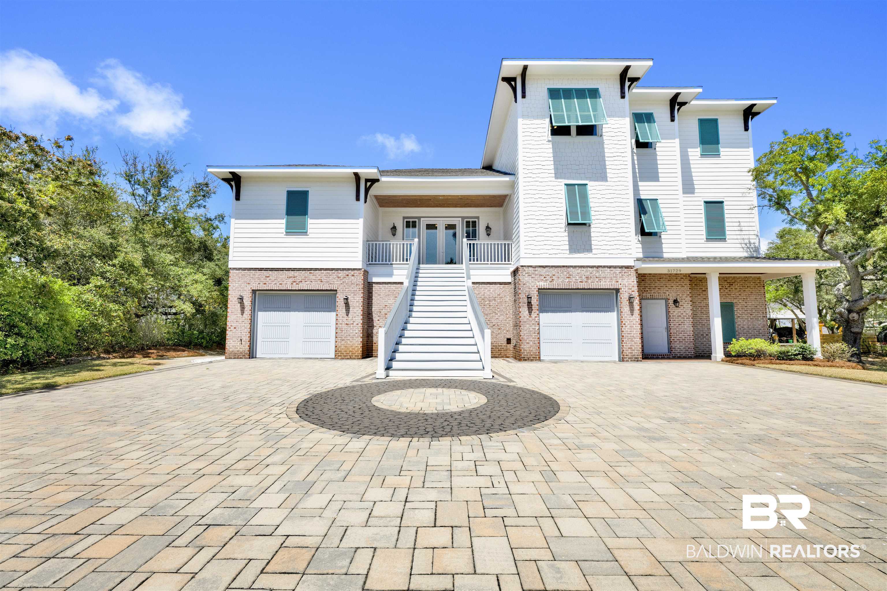 31729 River Road Orange Beach, AL 36561 - Photo 4 of 54 Beach home featuring french doors, a balcony, brick siding, and an attached garage