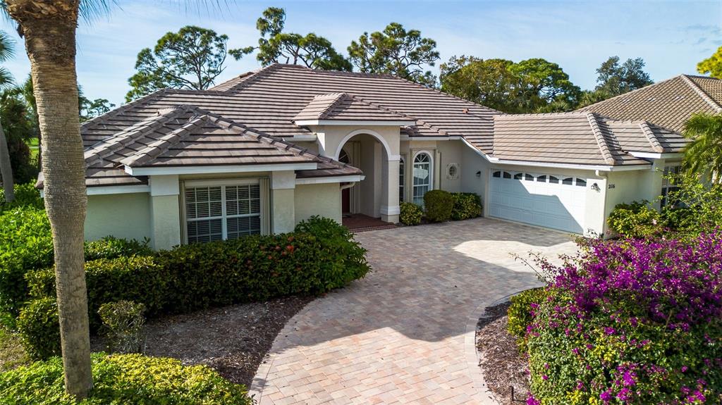 2116 Muskogee Trail Nokomis, FL 34275 - Photo 11 of 62 a front view of a house with a yard