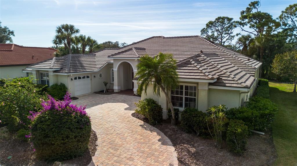2116 Muskogee Trail Nokomis, FL 34275 - Photo 12 of 62 a front view of a house with a yard