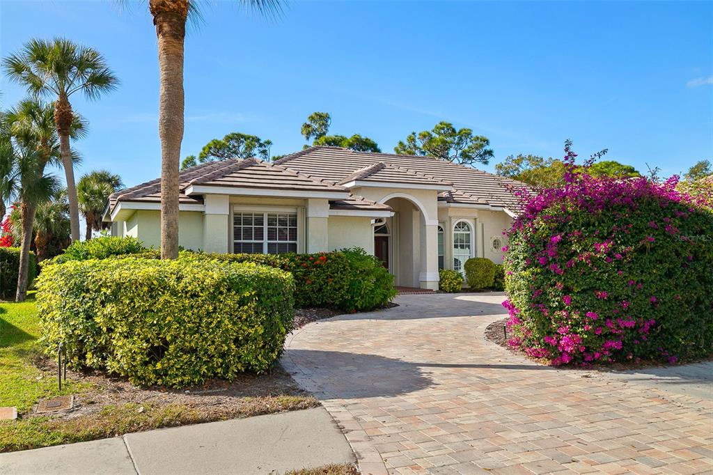 2116 Muskogee Trail Nokomis, FL 34275 - Photo 13 of 62 a front view of a house with a garden