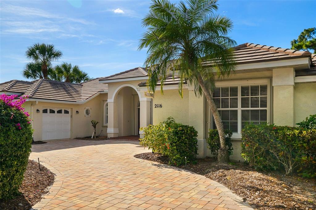 2116 Muskogee Trail Nokomis, FL 34275 - Photo 14 of 62 a front view of a house with a garden