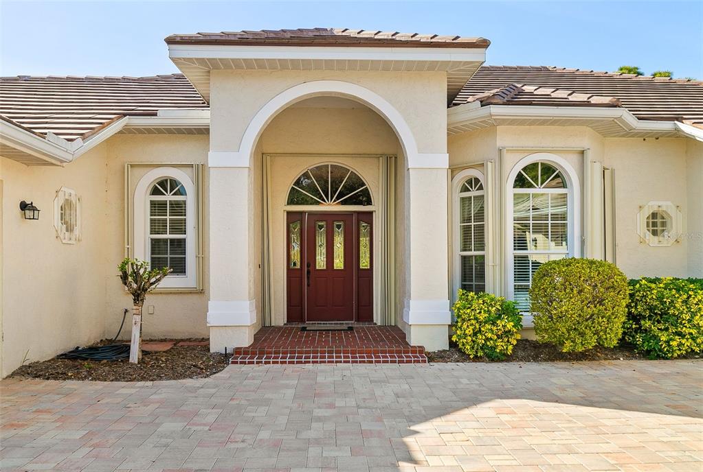 2116 Muskogee Trail Nokomis, FL 34275 - Photo 16 of 62 a front view of a house with garden