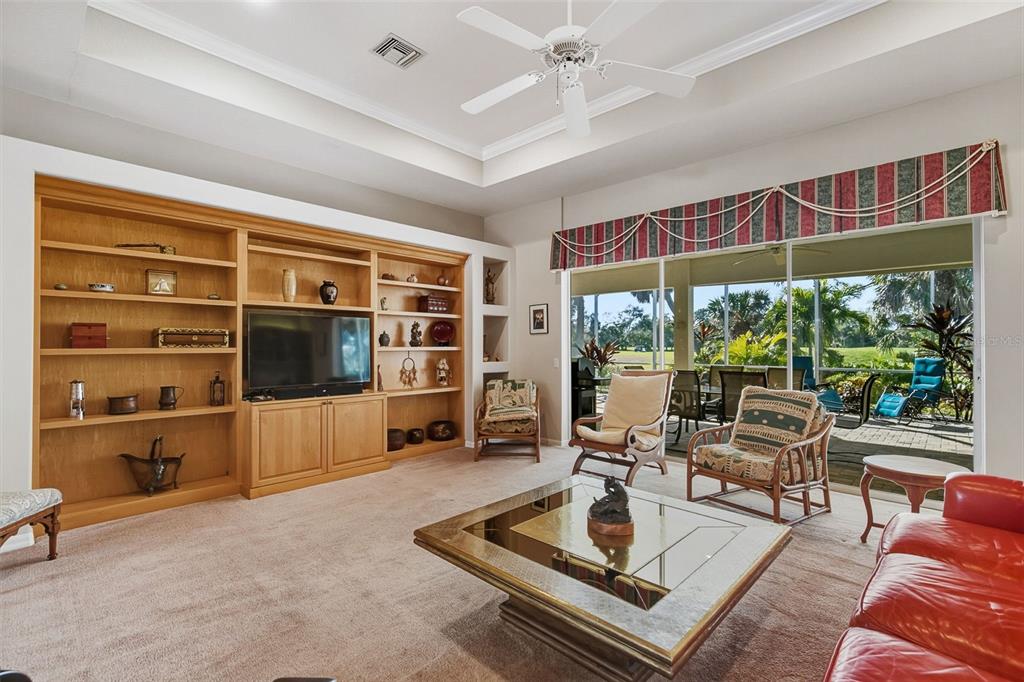 2116 Muskogee Trail Nokomis, FL 34275 - Photo 20 of 62 a living room with furniture a flat screen tv and floor to ceiling window