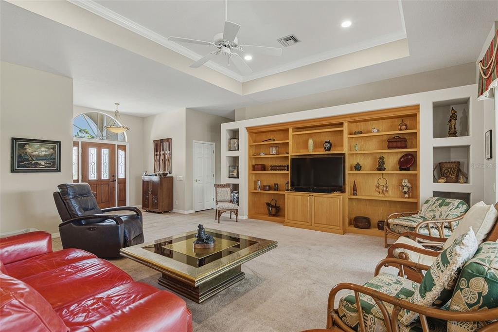 2116 Muskogee Trail Nokomis, FL 34275 - Photo 22 of 62 a living room with furniture a flat screen tv and a large window
