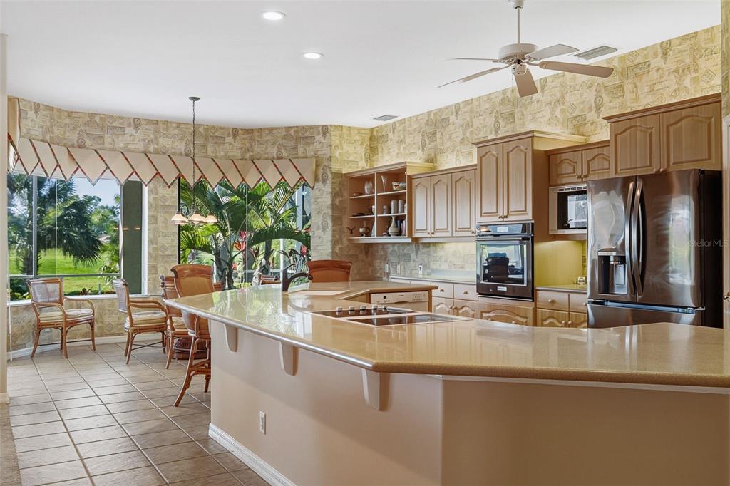 2116 Muskogee Trail Nokomis, FL 34275 - Photo 26 of 62 a kitchen with stainless steel appliances granite countertop a sink and a refrigerator