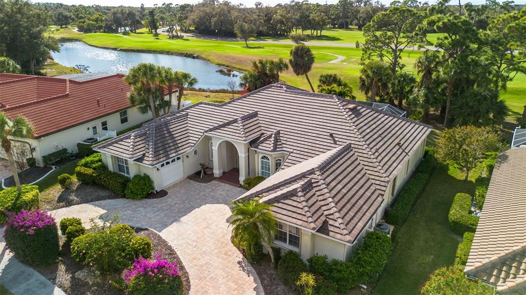 2116 Muskogee Trail Nokomis, FL 34275 - Photo 3 of 62 an aerial view of a house with a garden and lake view