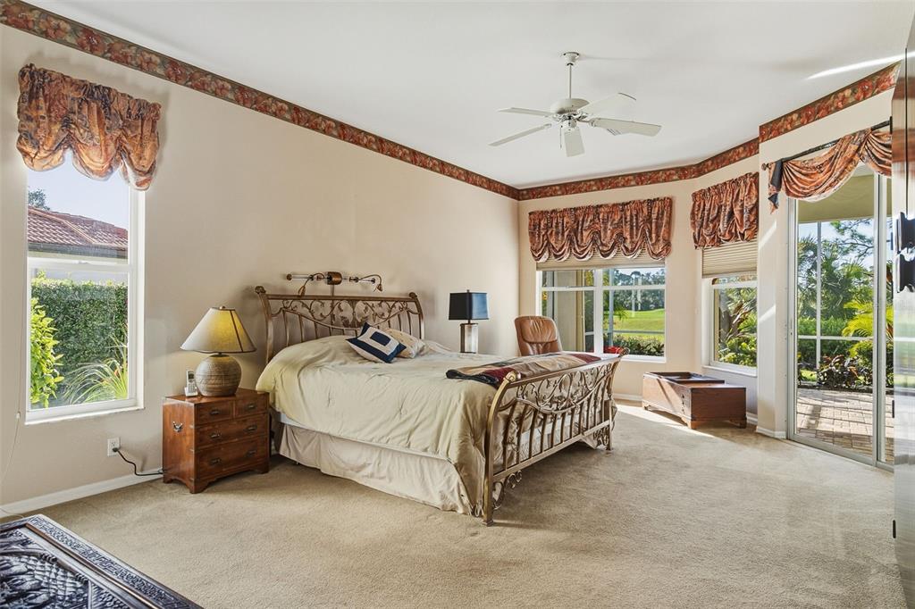 2116 Muskogee Trail Nokomis, FL 34275 - Photo 34 of 62 a bedroom with a bed and a large window