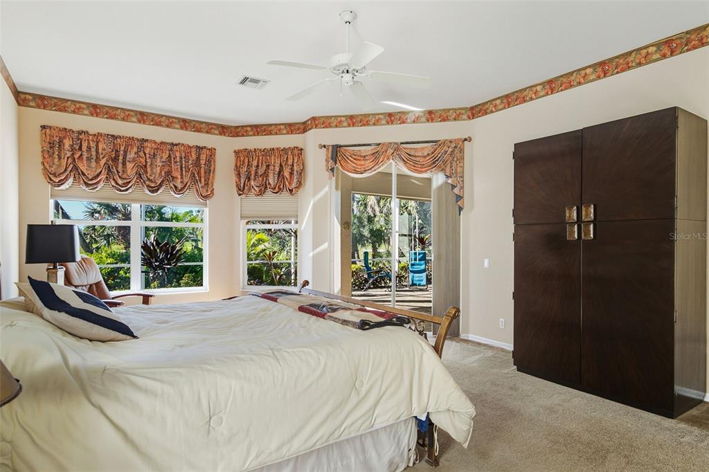 2116 Muskogee Trail Nokomis, FL 34275 - Photo 35 of 62 a bedroom with large window and a bed