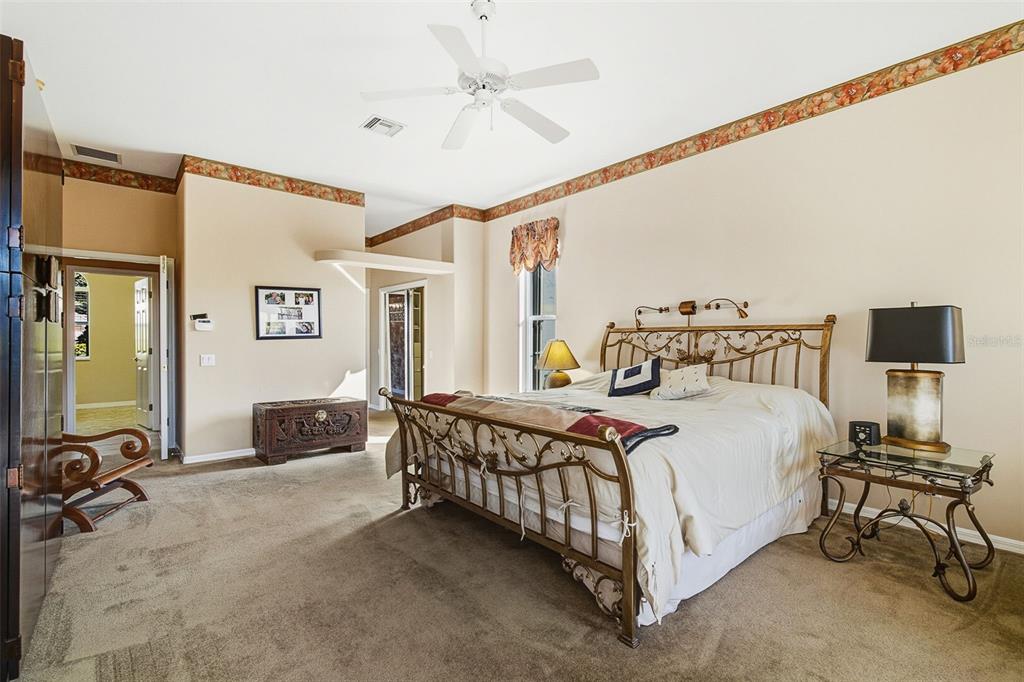 2116 Muskogee Trail Nokomis, FL 34275 - Photo 37 of 62 a bedroom with a bed and a table with the outer view