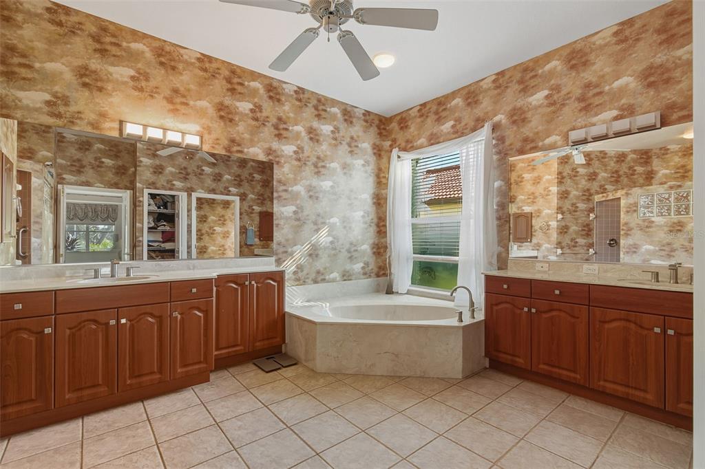 2116 Muskogee Trail Nokomis, FL 34275 - Photo 38 of 62 a bathroom with a tub sink shower and mirror