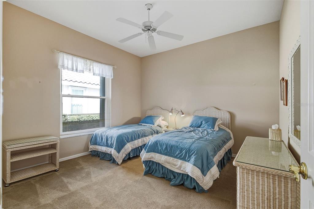 2116 Muskogee Trail Nokomis, FL 34275 - Photo 39 of 62 a bedroom with two beds and a window