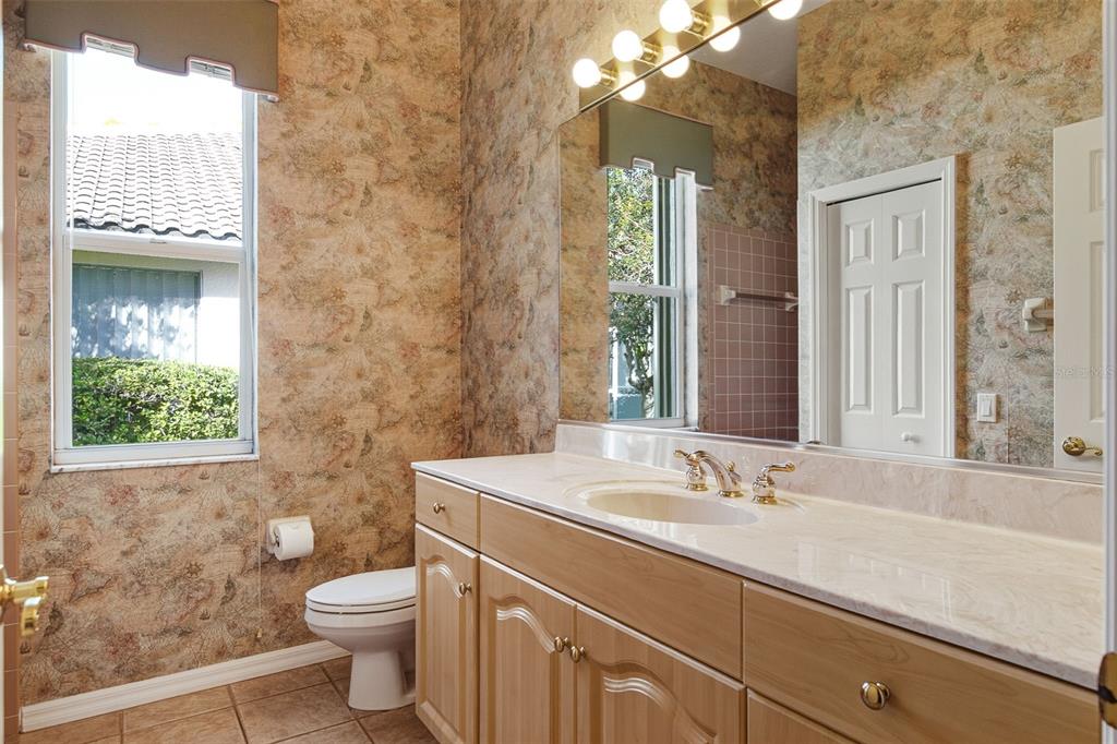 2116 Muskogee Trail Nokomis, FL 34275 - Photo 40 of 62 a bathroom with a sink toilet and window