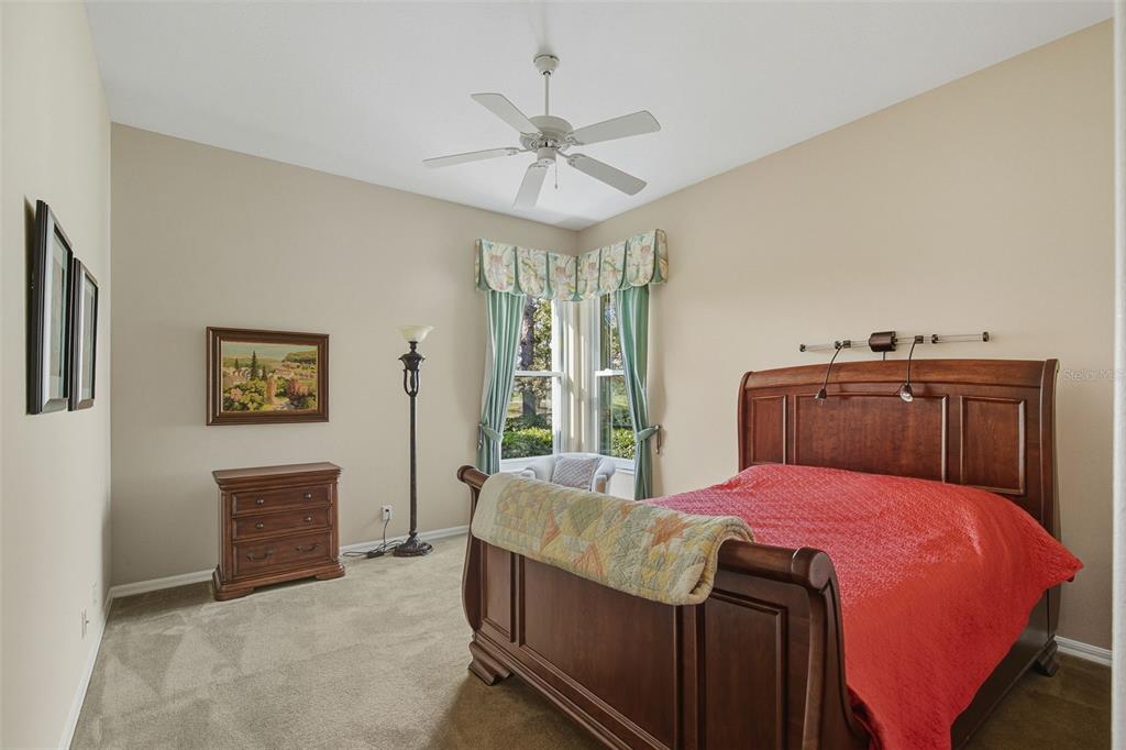 2116 Muskogee Trail Nokomis, FL 34275 - Photo 41 of 62 a bedroom with a bed and a chandelier