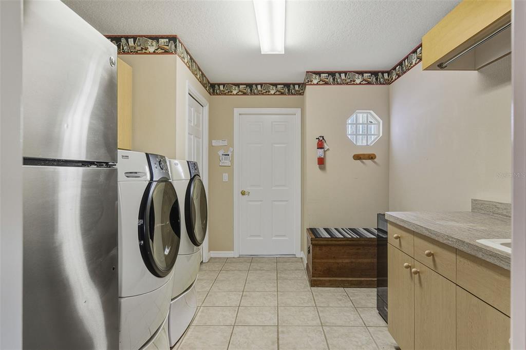 2116 Muskogee Trail Nokomis, FL 34275 - Photo 45 of 62 a utility room with dryer and washer