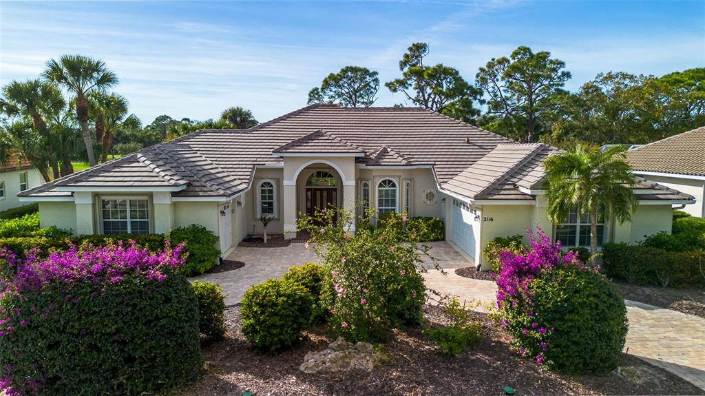 2116 Muskogee Trail Nokomis, FL 34275 - Photo 10 of 62 a view of a house with a big yard and potted plants