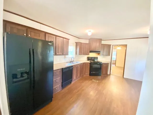 a kitchen with a refrigerator a sink and dishwasher