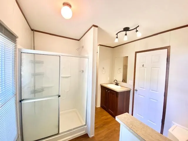 a bathroom with a sink and mirror with bathtub