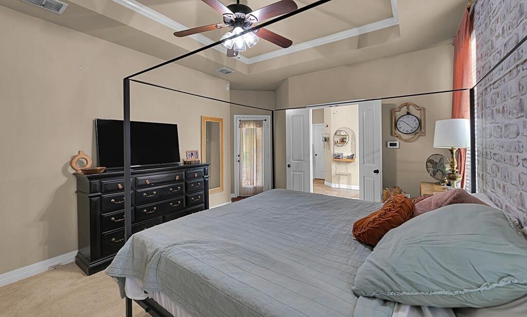 550 Hunton Lane Robinson, TX 76706 - Photo 15 of 35 Bedroom with light carpet, a ceiling fan, and a tray ceiling