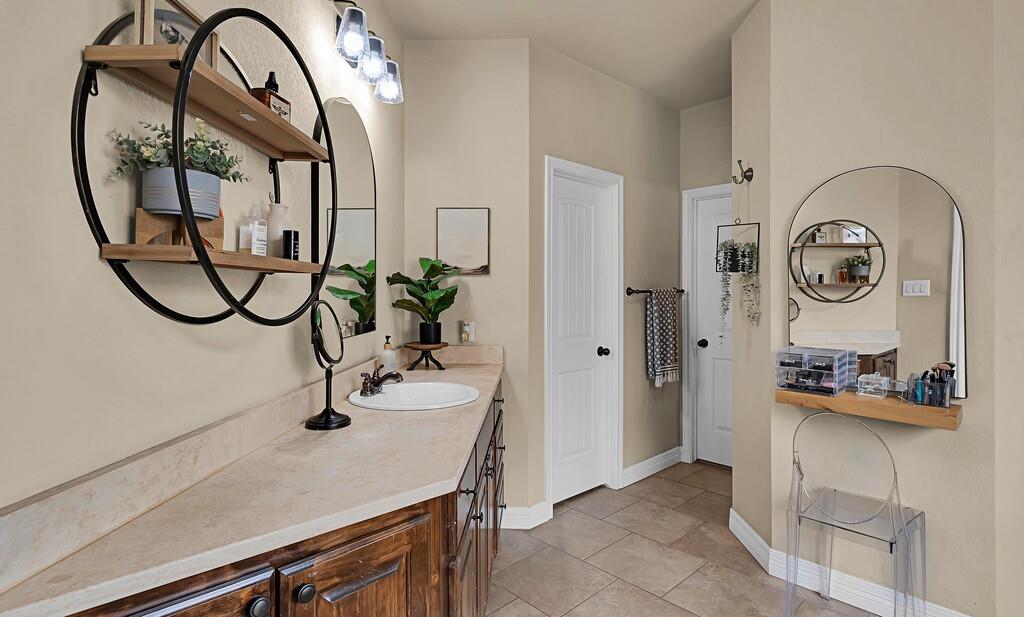 550 Hunton Lane Robinson, TX 76706 - Photo 16 of 35 Full bathroom featuring vanity and baseboards