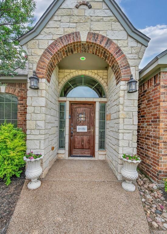 550 Hunton Lane Robinson, TX 76706 - Photo 3 of 35 Doorway to property featuring stone siding and brick siding