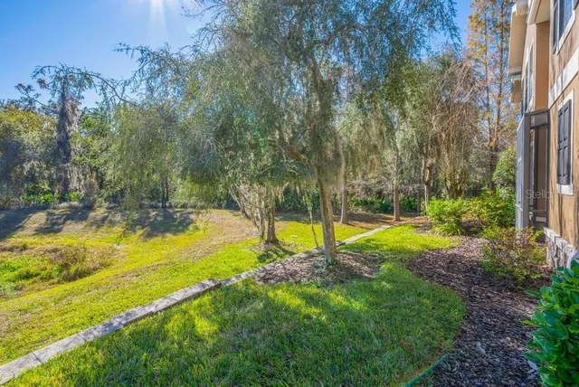 a view of a backyard with swimming pool