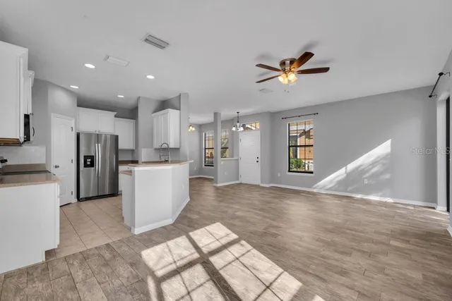 a view of a kitchen with a sink and a refrigerator