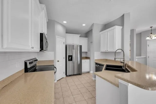 a kitchen that has a sink and a stove in it