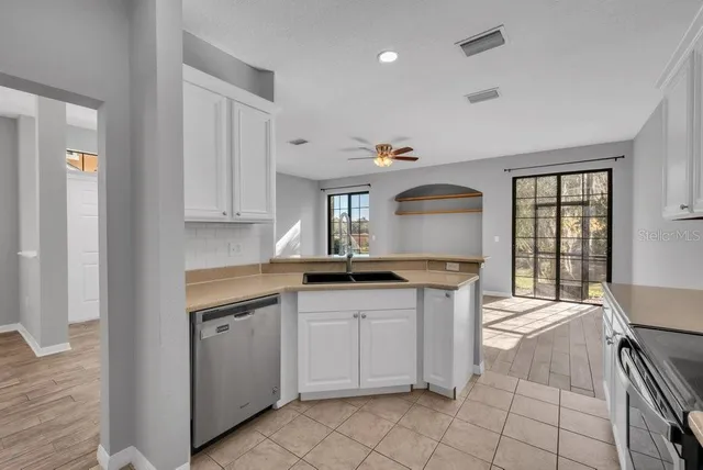 a kitchen with granite countertop a sink and cabinets