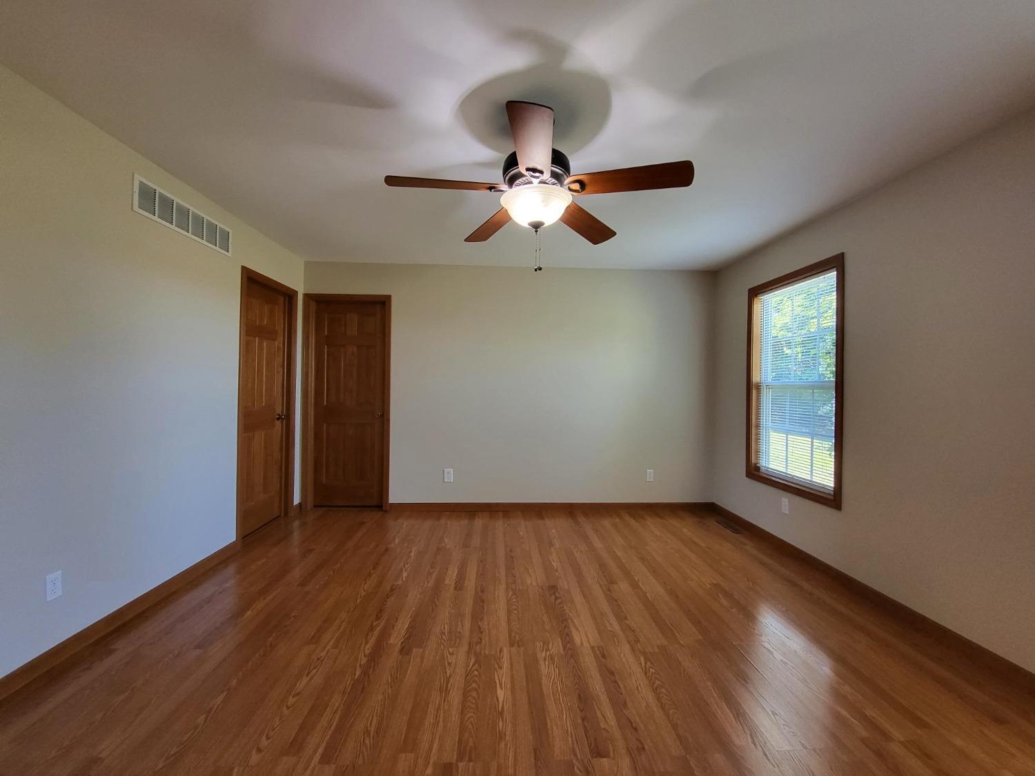 412 Juniper Street Northwest De Motte, IN 46310 - Photo 20 of 23 a view of empty room with wooden floor and fan