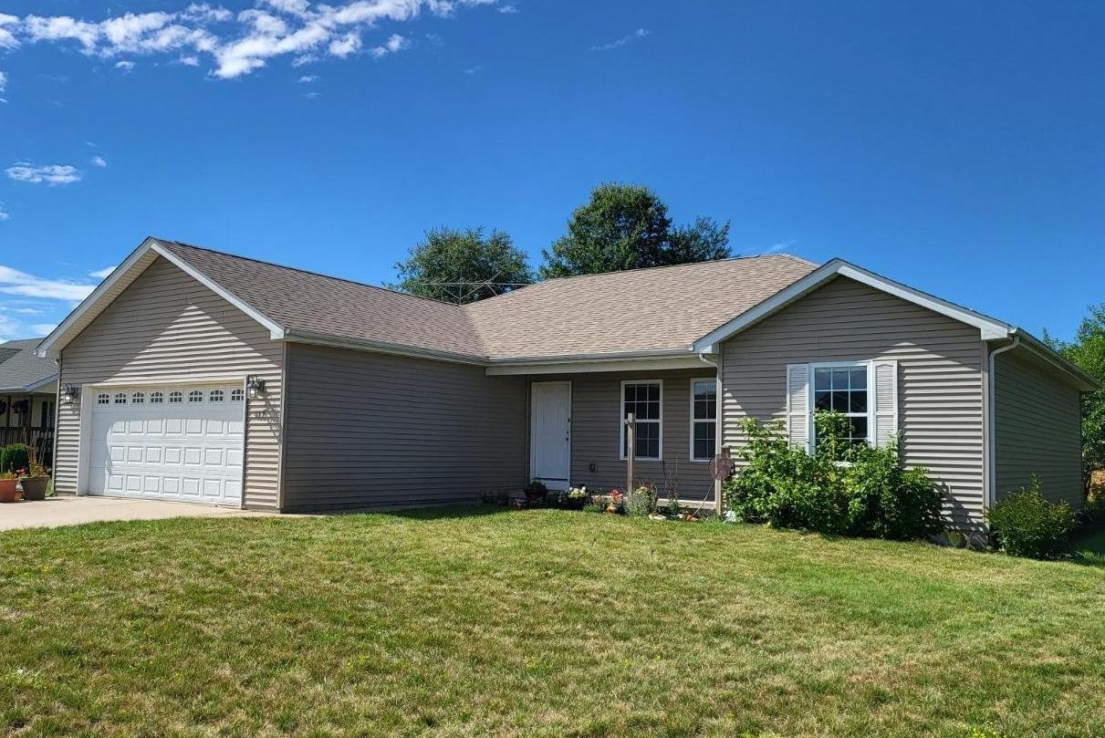 412 Juniper Street Northwest De Motte, IN 46310 - Photo 2 of 23 a view of a house with a yard and large tree