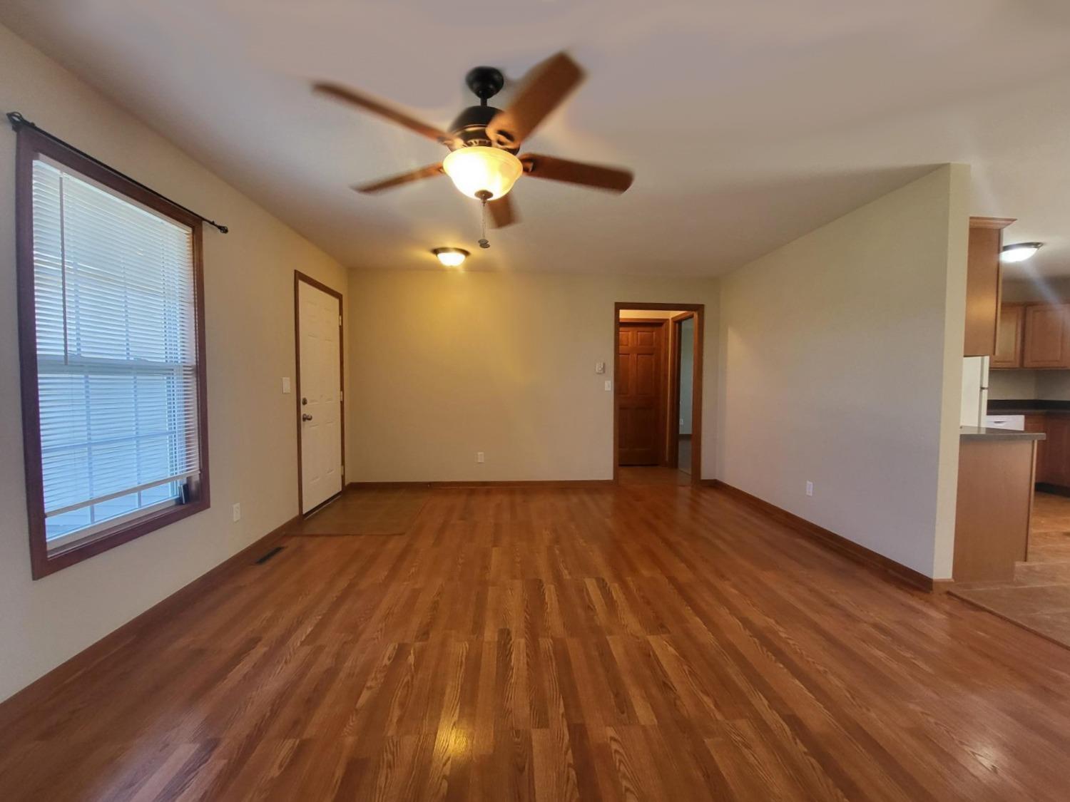 412 Juniper Street Northwest De Motte, IN 46310 - Photo 4 of 23 a view of an empty room with wooden floor and a window