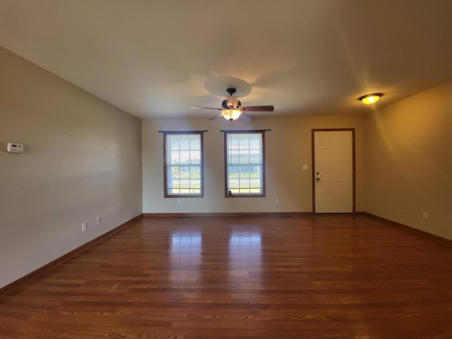 412 Juniper Street Northwest De Motte, IN 46310 - Photo 5 of 23 a view of an empty room with window and wooden floor