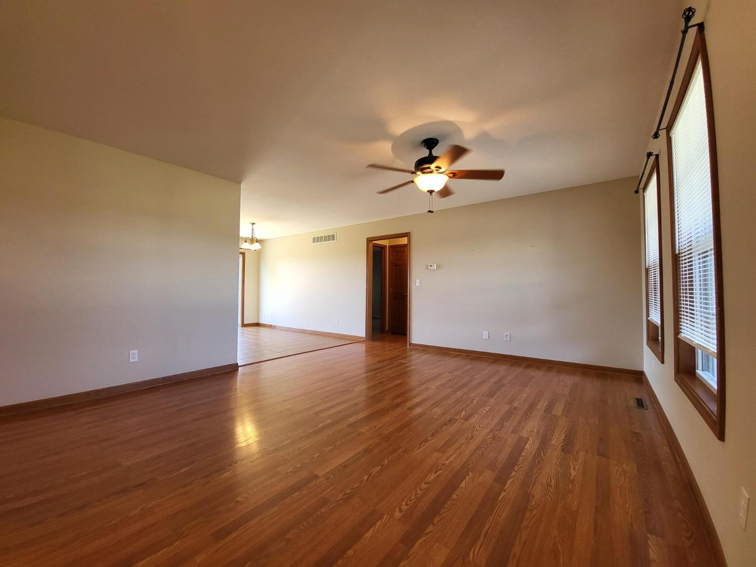 412 Juniper Street Northwest De Motte, IN 46310 - Photo 7 of 23 a view of an empty room with wooden floor and a window