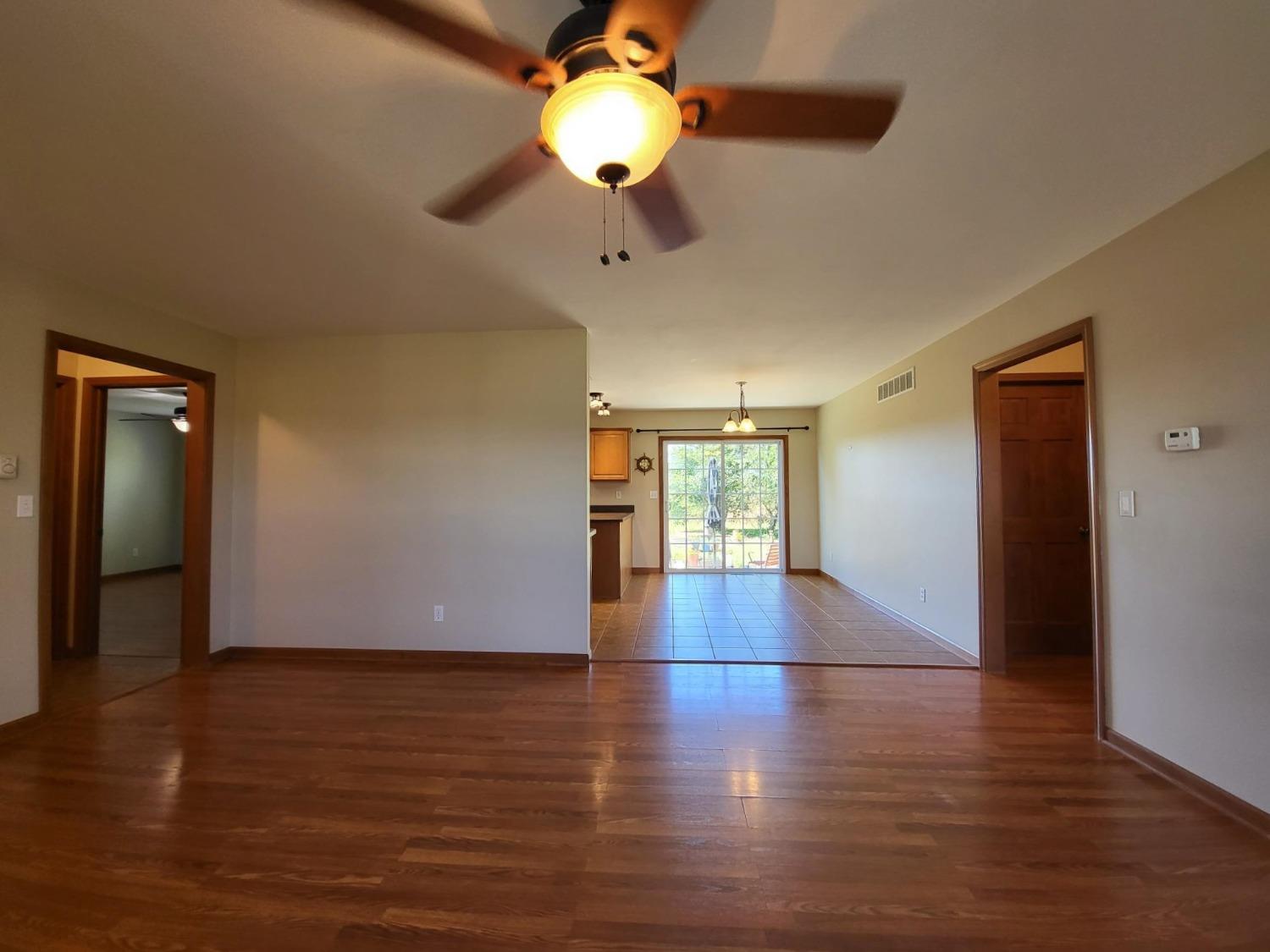 412 Juniper Street Northwest De Motte, IN 46310 - Photo 8 of 23 a view of an empty room with wooden floor and a window
