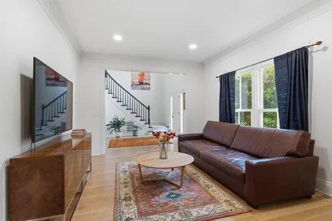 a kitchen with stainless steel appliances granite countertop white cabinets sink and window