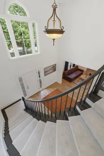 an aerial view of residential house with outdoor space and trees all around