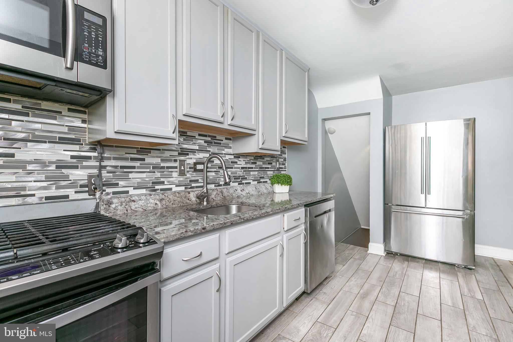 4921 St Gemma Road Baltimore, MD 21229 - Photo 13 of 33 a kitchen with appliances and cabinets