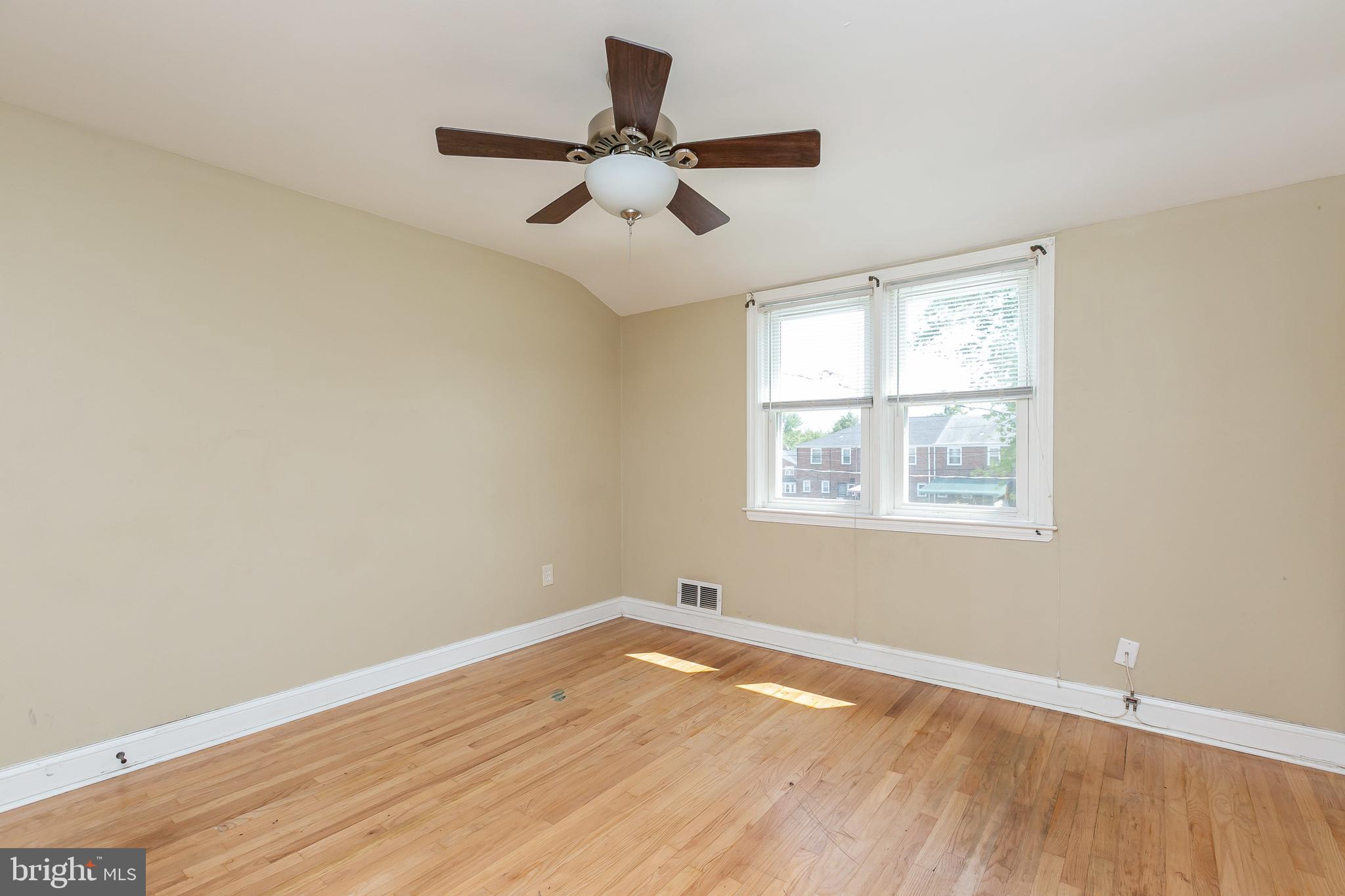 4921 St Gemma Road Baltimore, MD 21229 - Photo 16 of 33 an empty room with wooden floor fan and windows