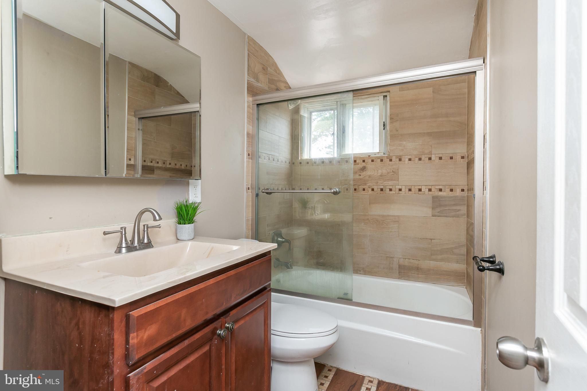 4921 St Gemma Road Baltimore, MD 21229 - Photo 20 of 33 a bathroom with a sink toilet and shower