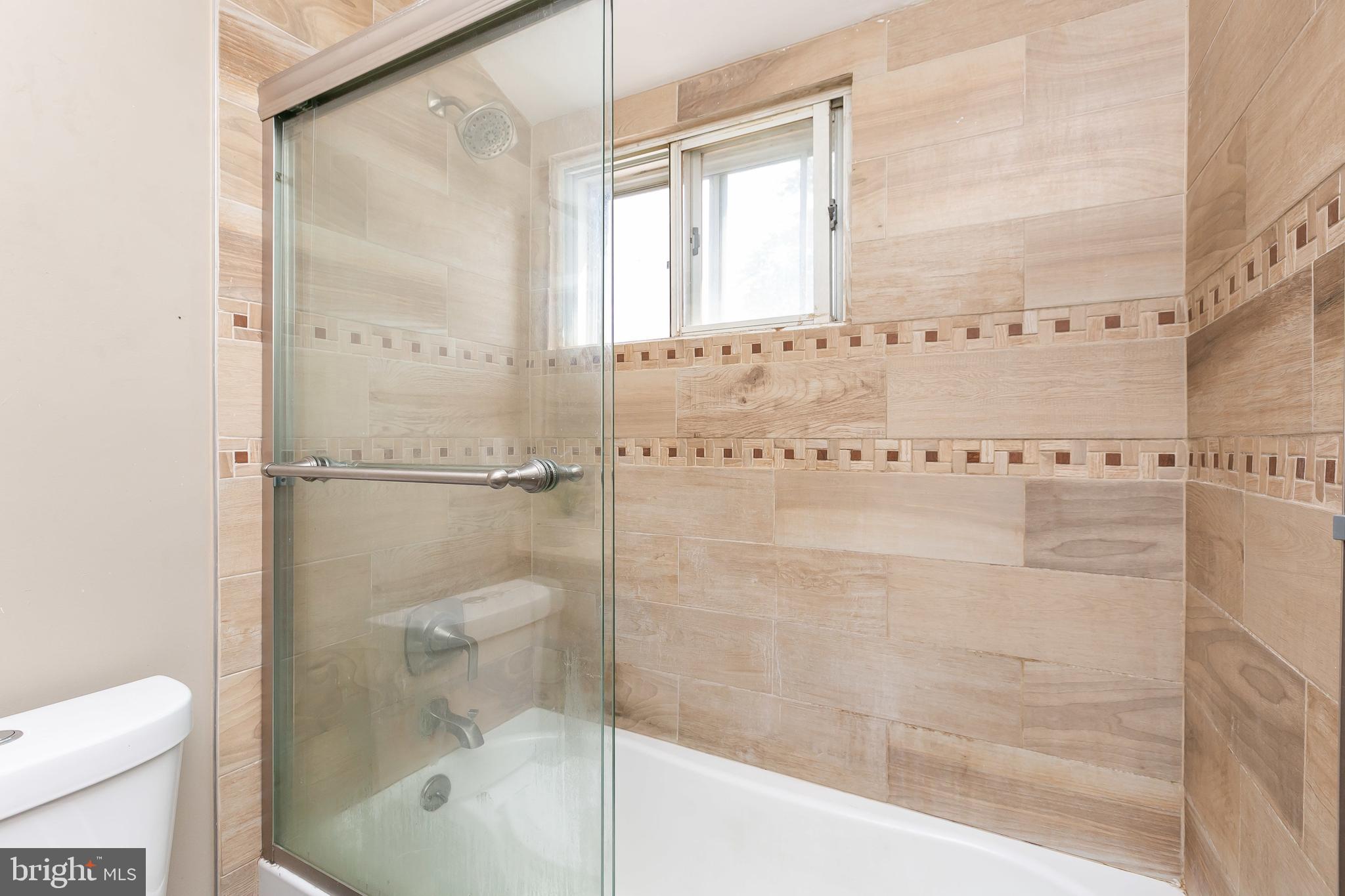 4921 St Gemma Road Baltimore, MD 21229 - Photo 21 of 33 a bathroom with a bathtub and a shower