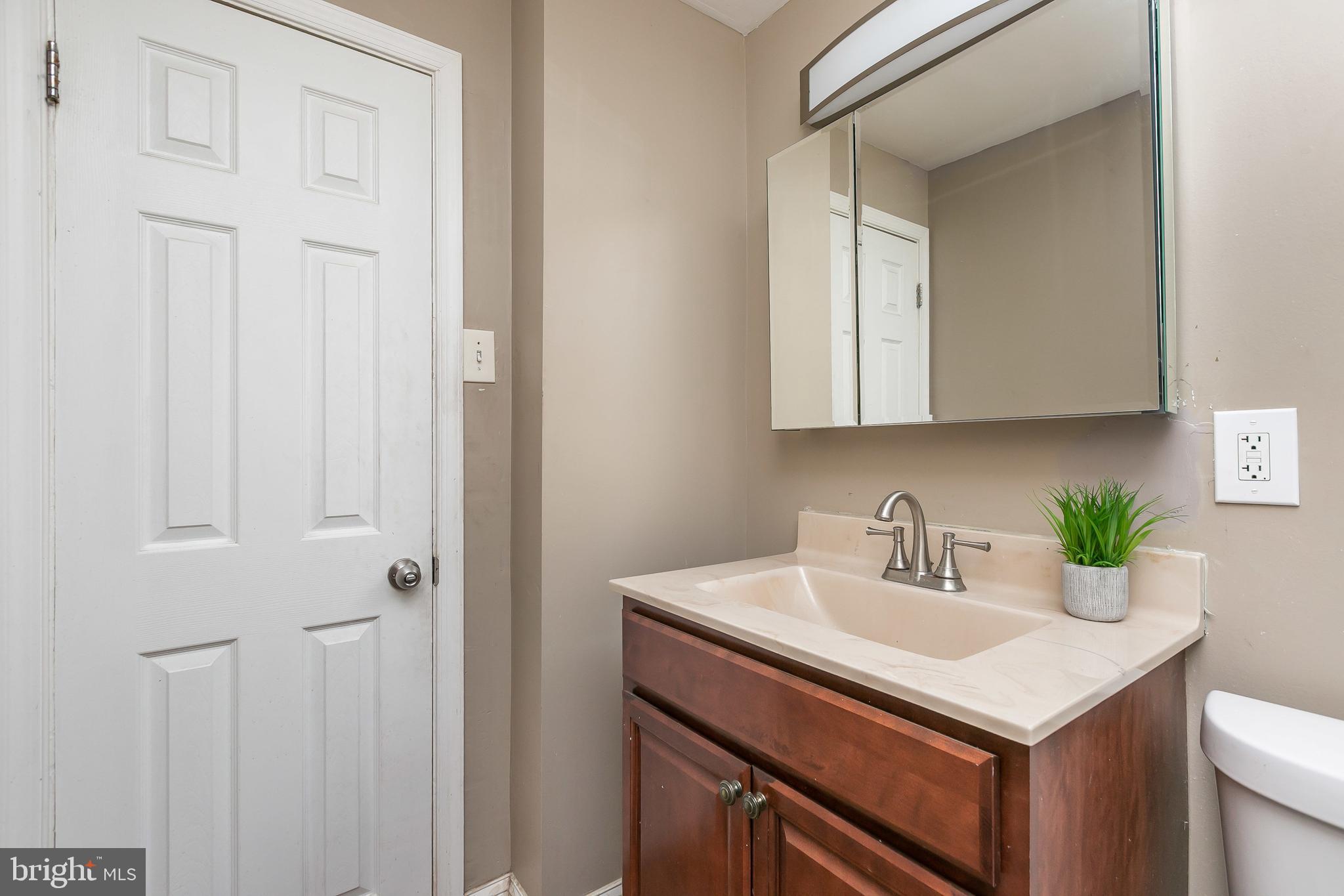 4921 St Gemma Road Baltimore, MD 21229 - Photo 22 of 33 a bathroom with a sink and a vanity