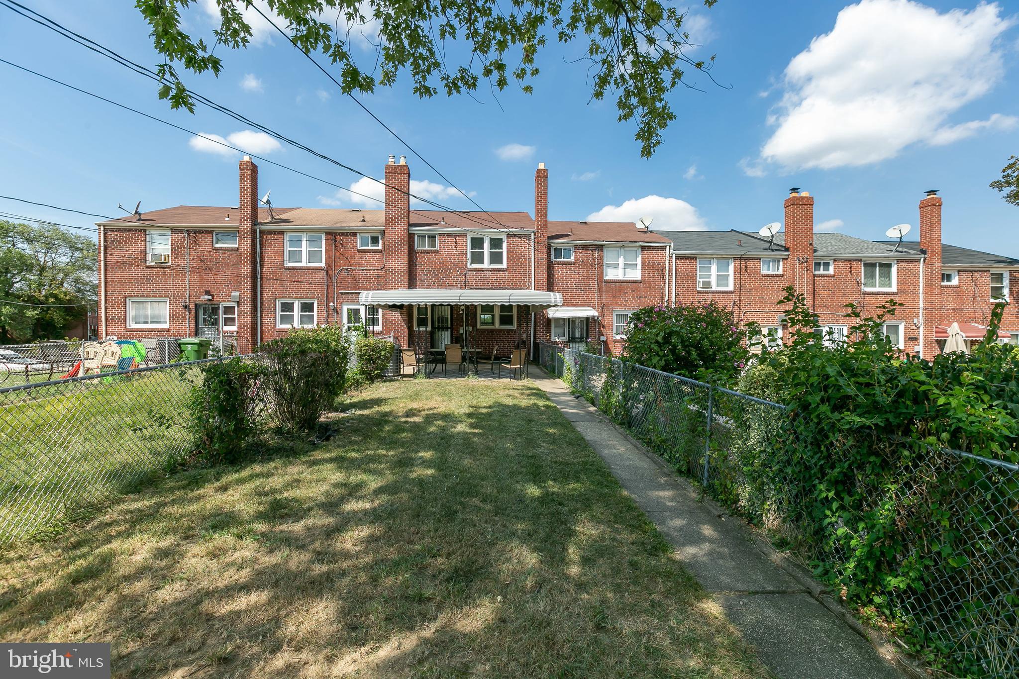 4921 St Gemma Road Baltimore, MD 21229 - Photo 28 of 33 a front view of a residential apartment building with a yard