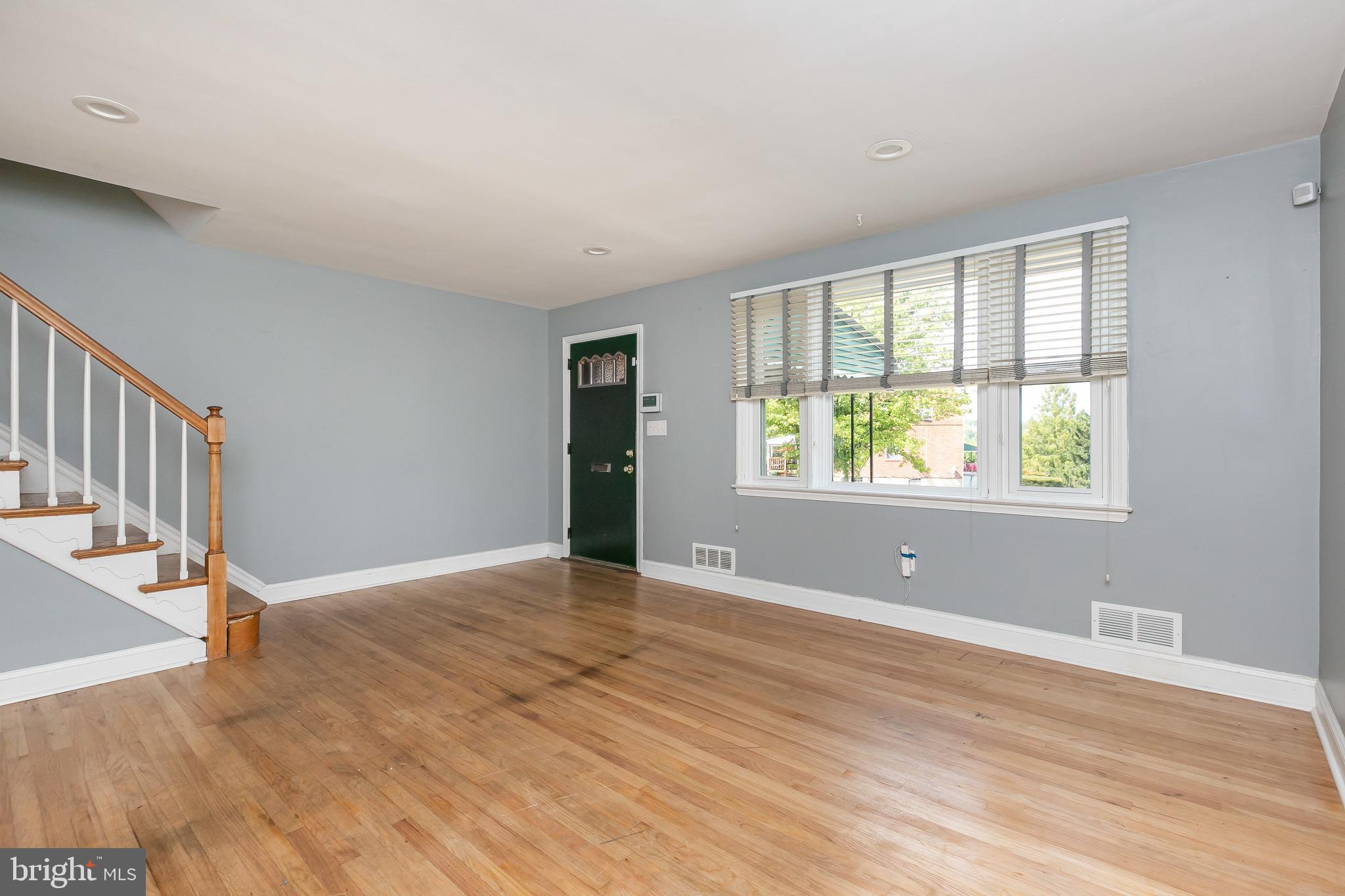4921 St Gemma Road Baltimore, MD 21229 - Photo 4 of 33 a view of an empty room with wooden floor and a window