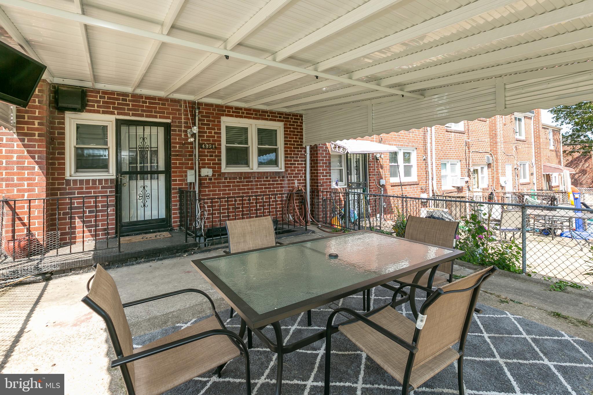 4921 St Gemma Road Baltimore, MD 21229 - Photo 31 of 33 a view of a patio with a table and chairs