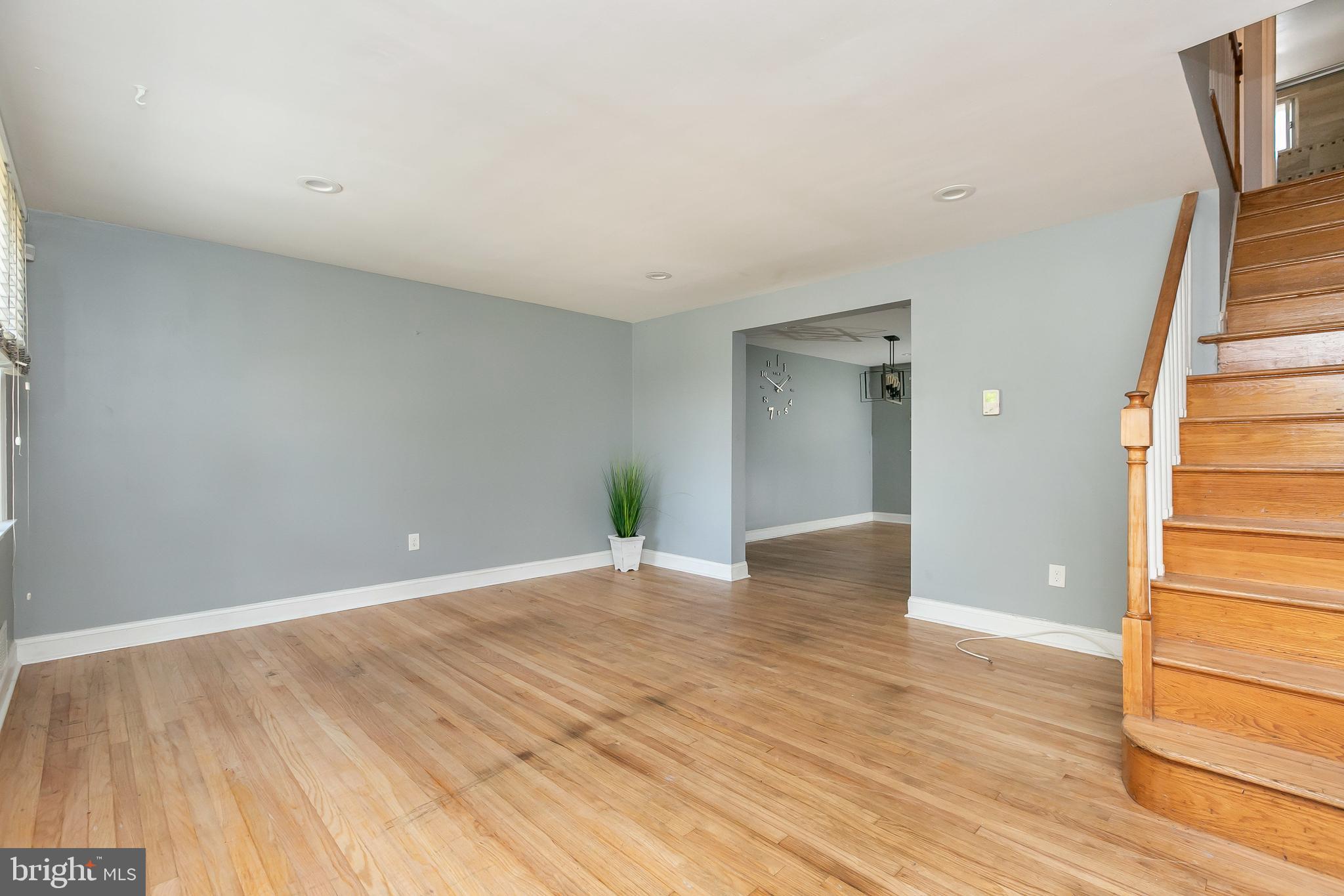 4921 St Gemma Road Baltimore, MD 21229 - Photo 5 of 33 a view of an empty room with wooden floor and stairs