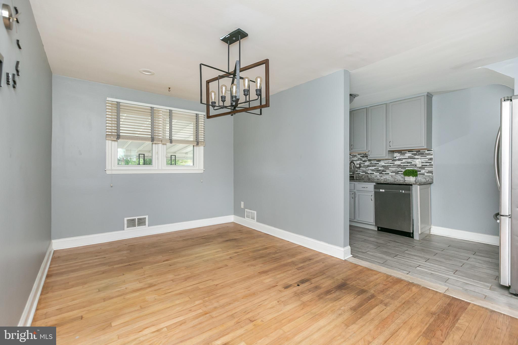 4921 St Gemma Road Baltimore, MD 21229 - Photo 9 of 33 a view of a kitchen with a sink dishwasher and wooden floor